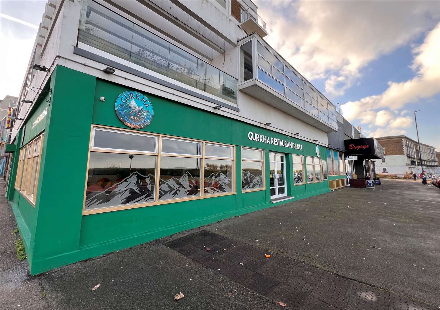 The green exterior of Gurkha Restaurant and Bar, next to Bugsy’s